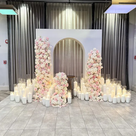 Floral columns, arch backdrop and candles for a celebration